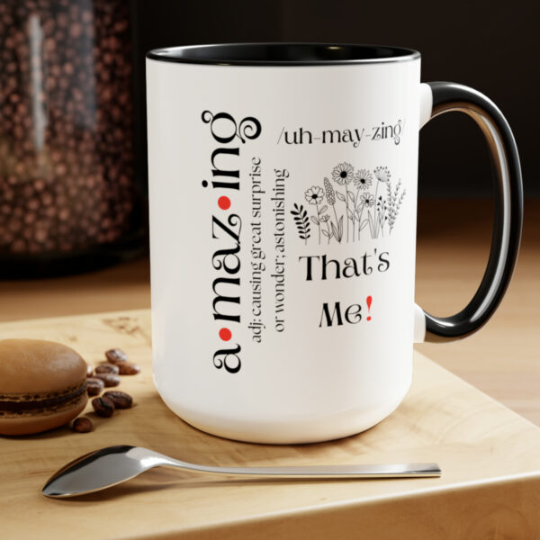amazing definition coffee mug in white and black (black handle and black interior) displayed on a table with a spoon and cookies