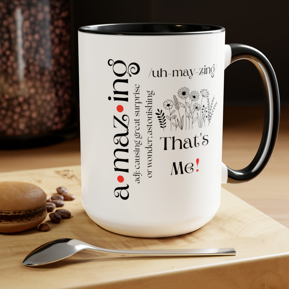 amazing definition coffee mug in white and black (black handle and black interior) displayed on a table with a spoon and cookies